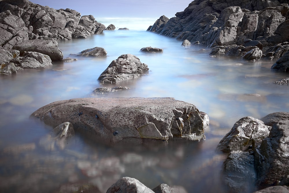 brown stone on body of water