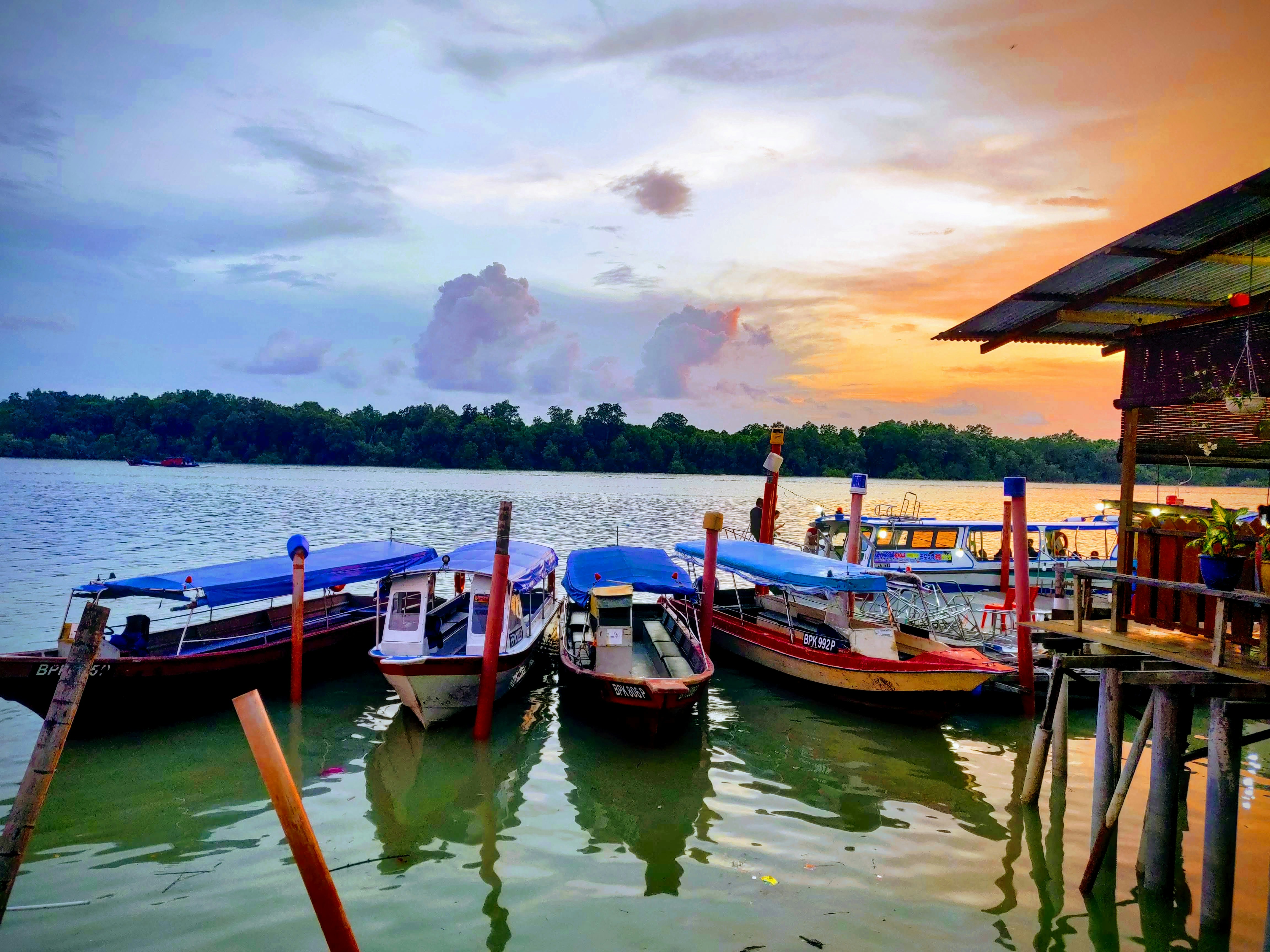 boats on body of water under cloudy sky during daytime