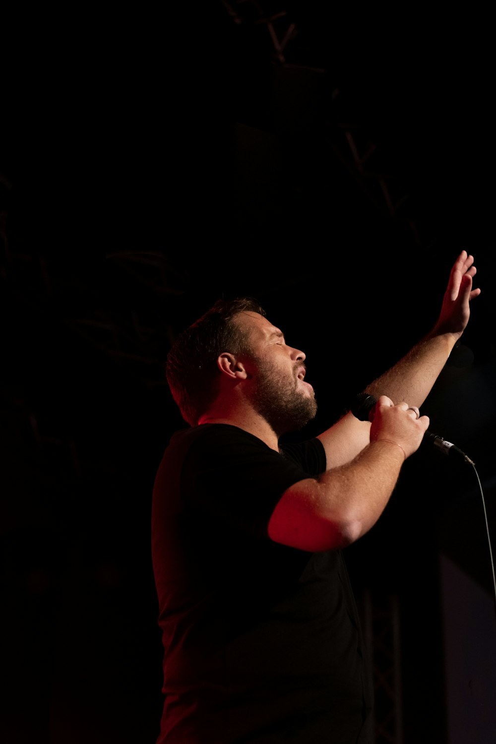 man singing in dimmed room