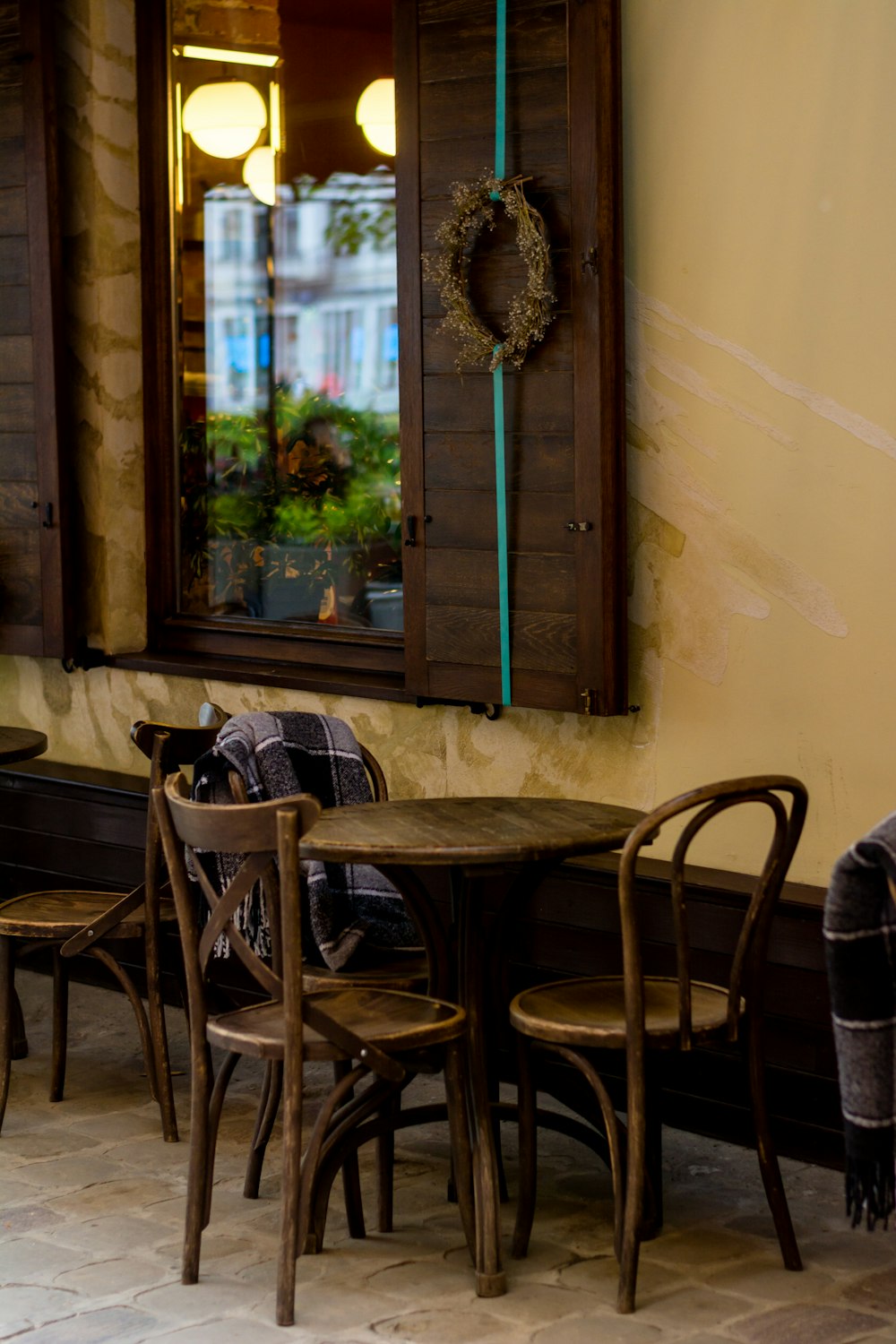 black wooden tables and chairs near wall