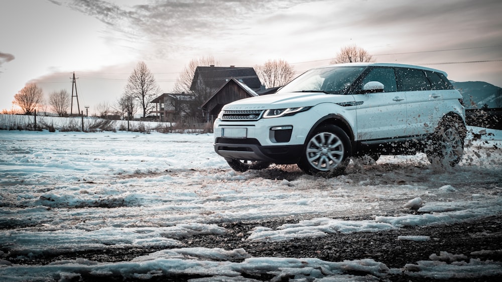 white SUV on snowy road