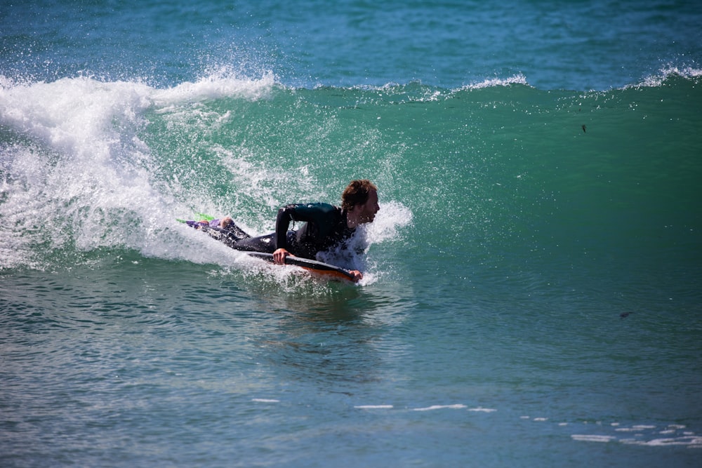 man surfing on sea wave