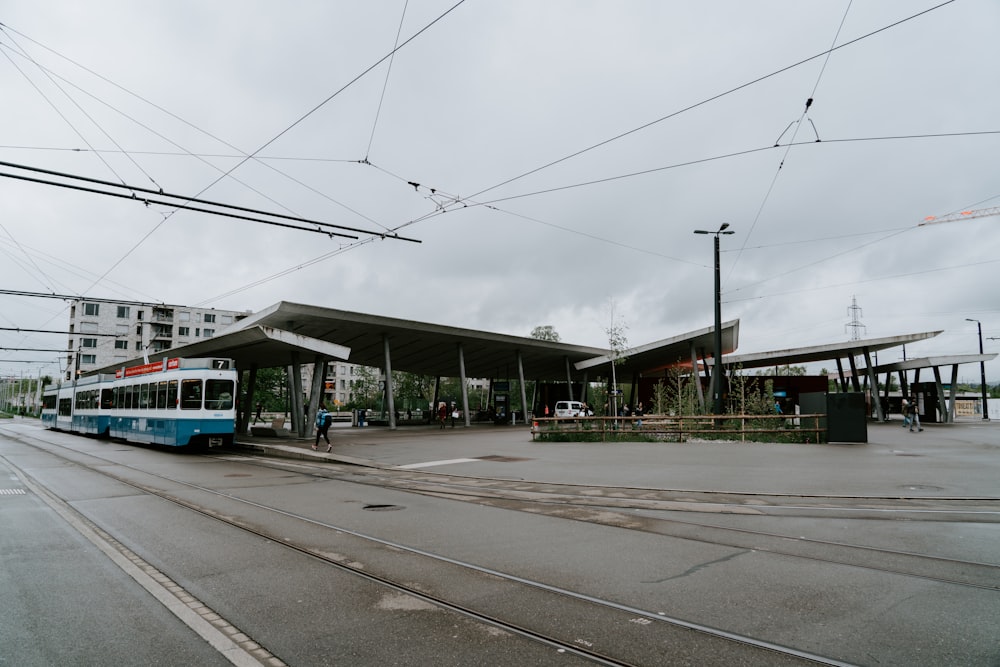 blue and white train in station