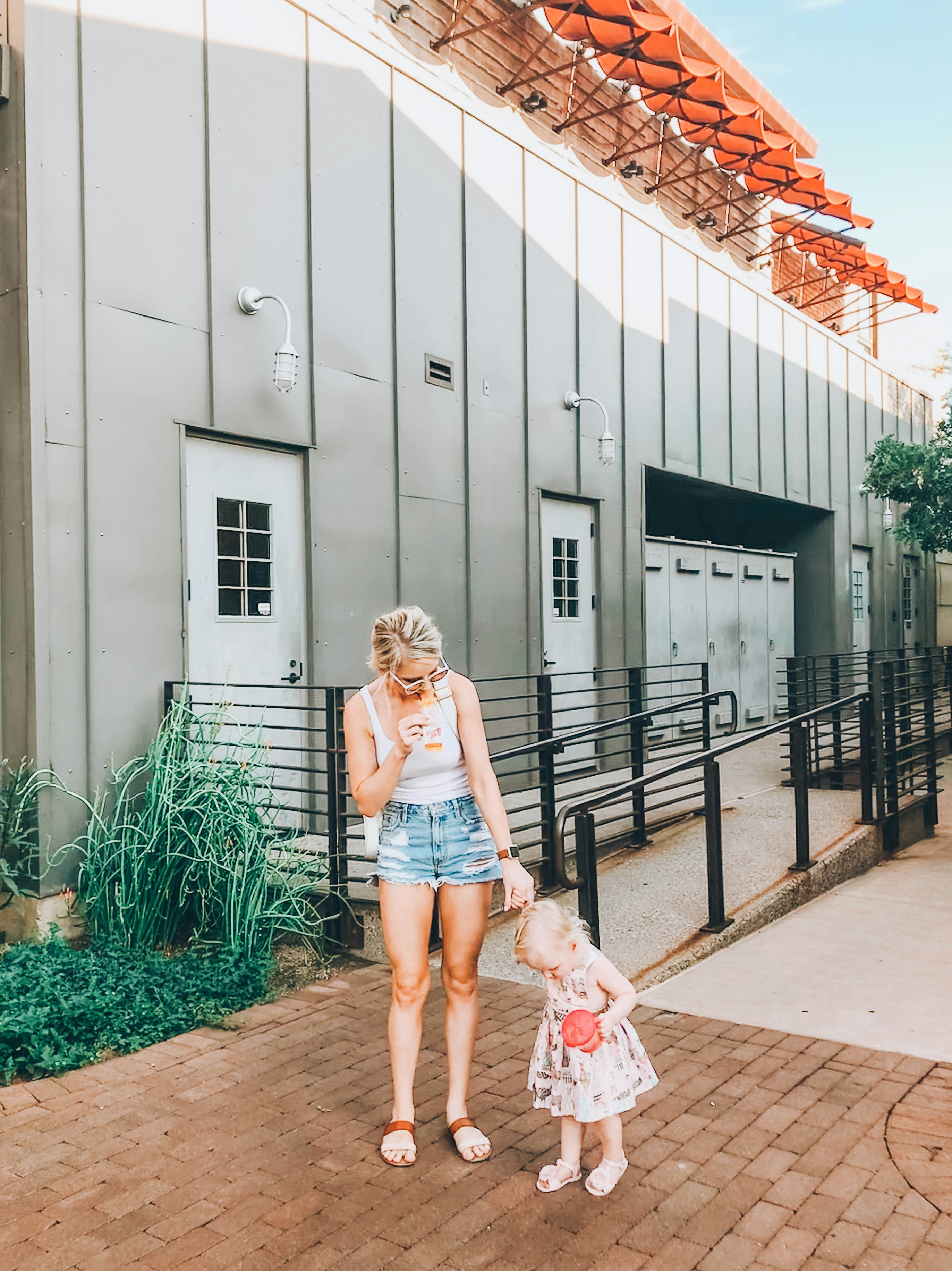 woman holding girl's hands