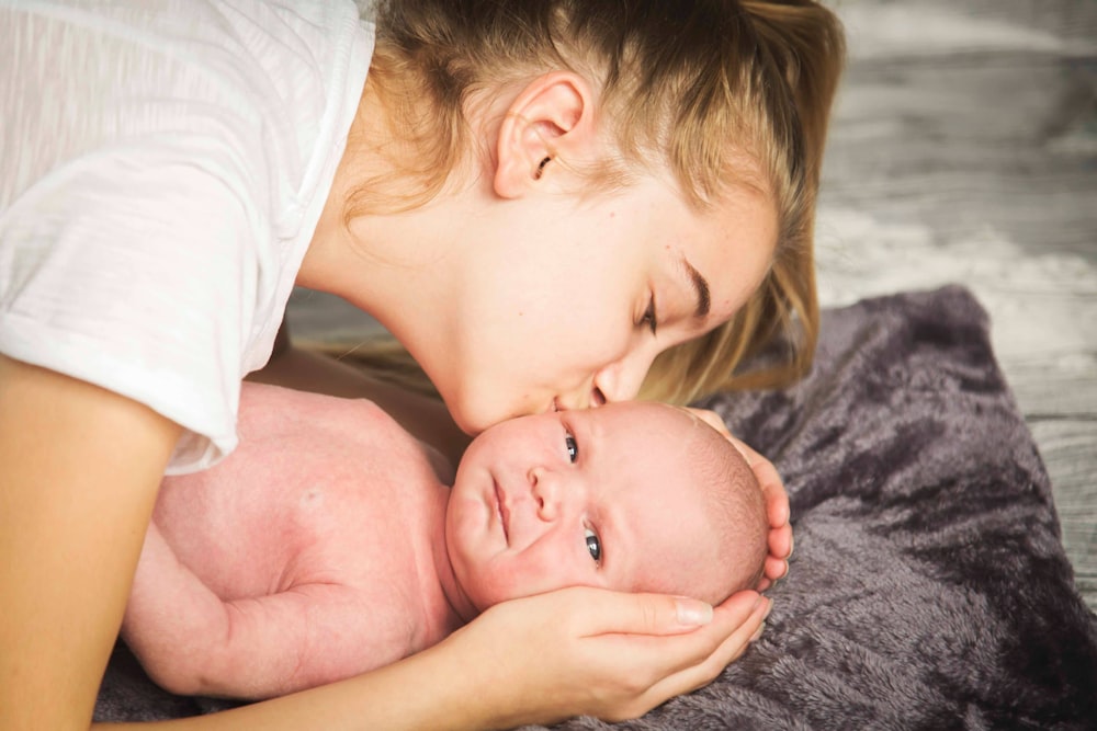 woman kissing baby