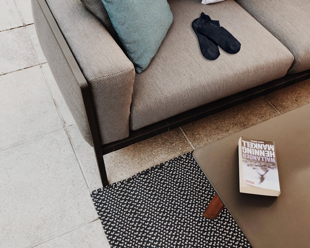 pair of black socks on gray sofa