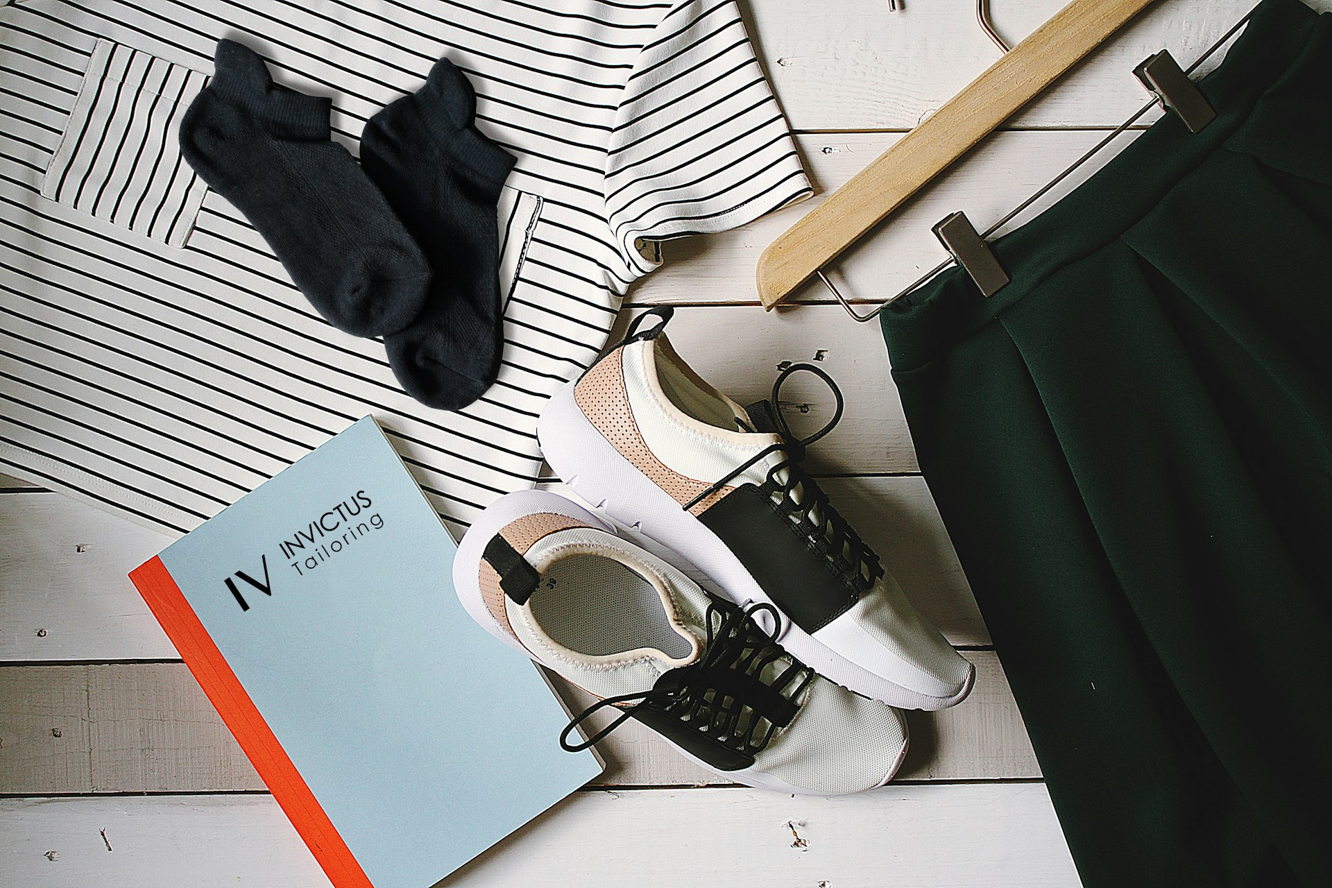 A flat lay of trendy clothes and accessories arranged neatly with price tags and labels.