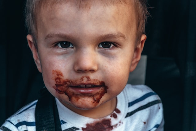 The image of a toddler's face after eating chocolate.