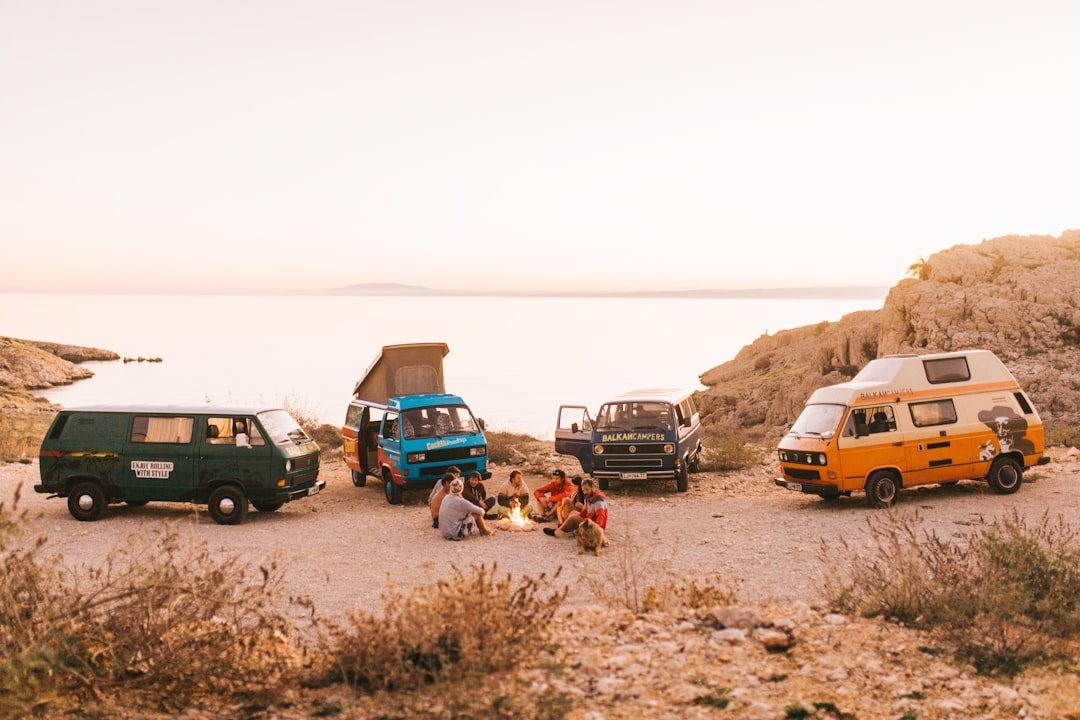 four assorted color vehicles outdoors,