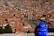 A man enjoying a scenic view of León's historic center with a camera.