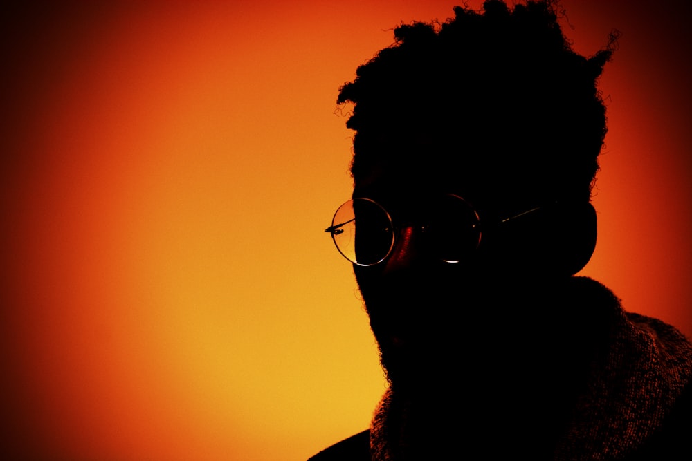 a silhouette of a man with glasses and a beard