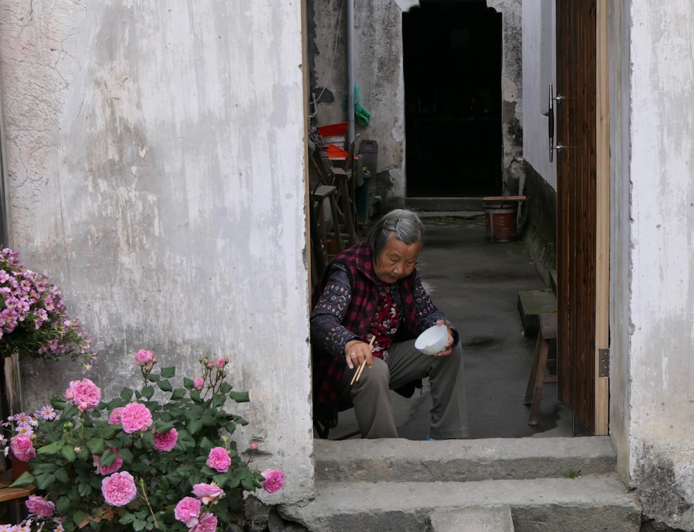 woman holding brown chopsticks