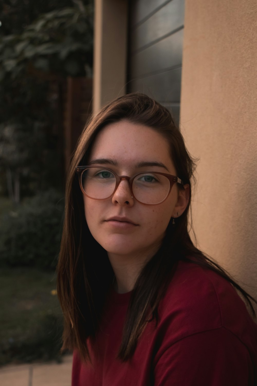 woman in red shirt wearing eyeglasses