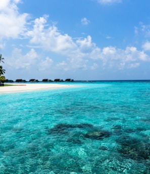 blue sea under white clouds at daytime