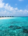 blue sea under white clouds at daytime