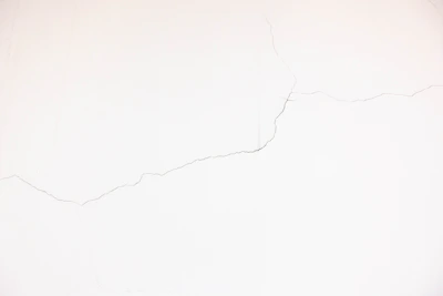A smooth drywall wall after crack repair, showing no visible damage.