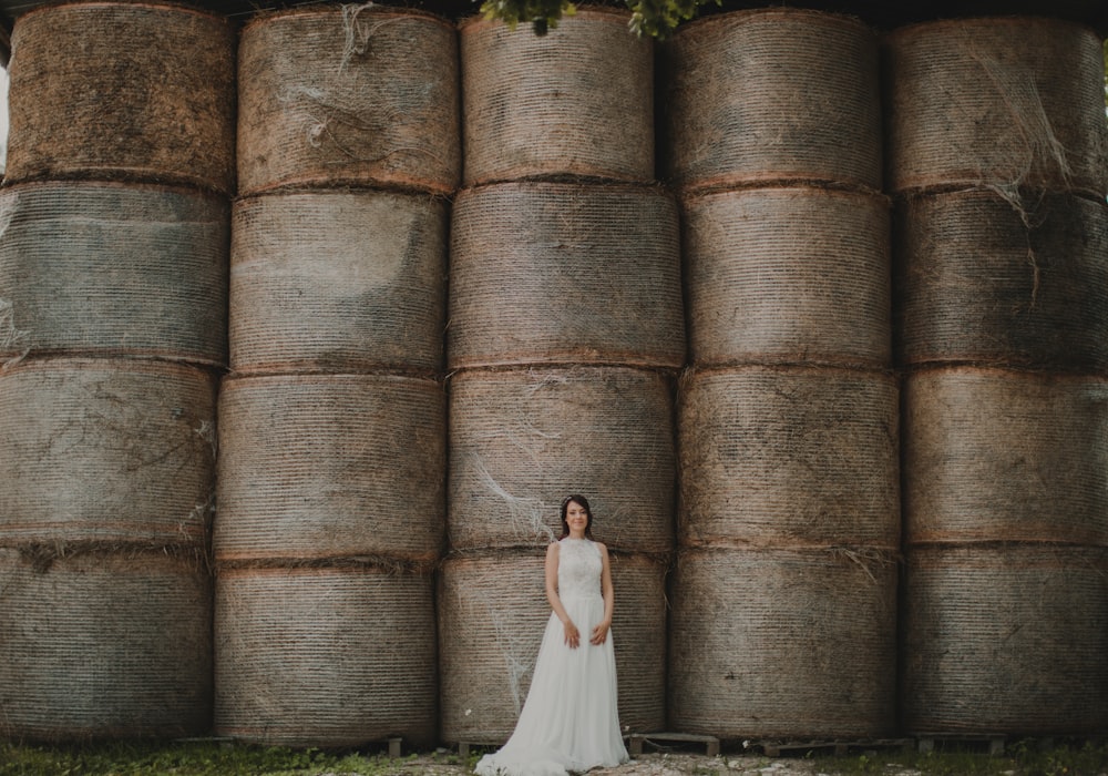 woman leaning near piled wood