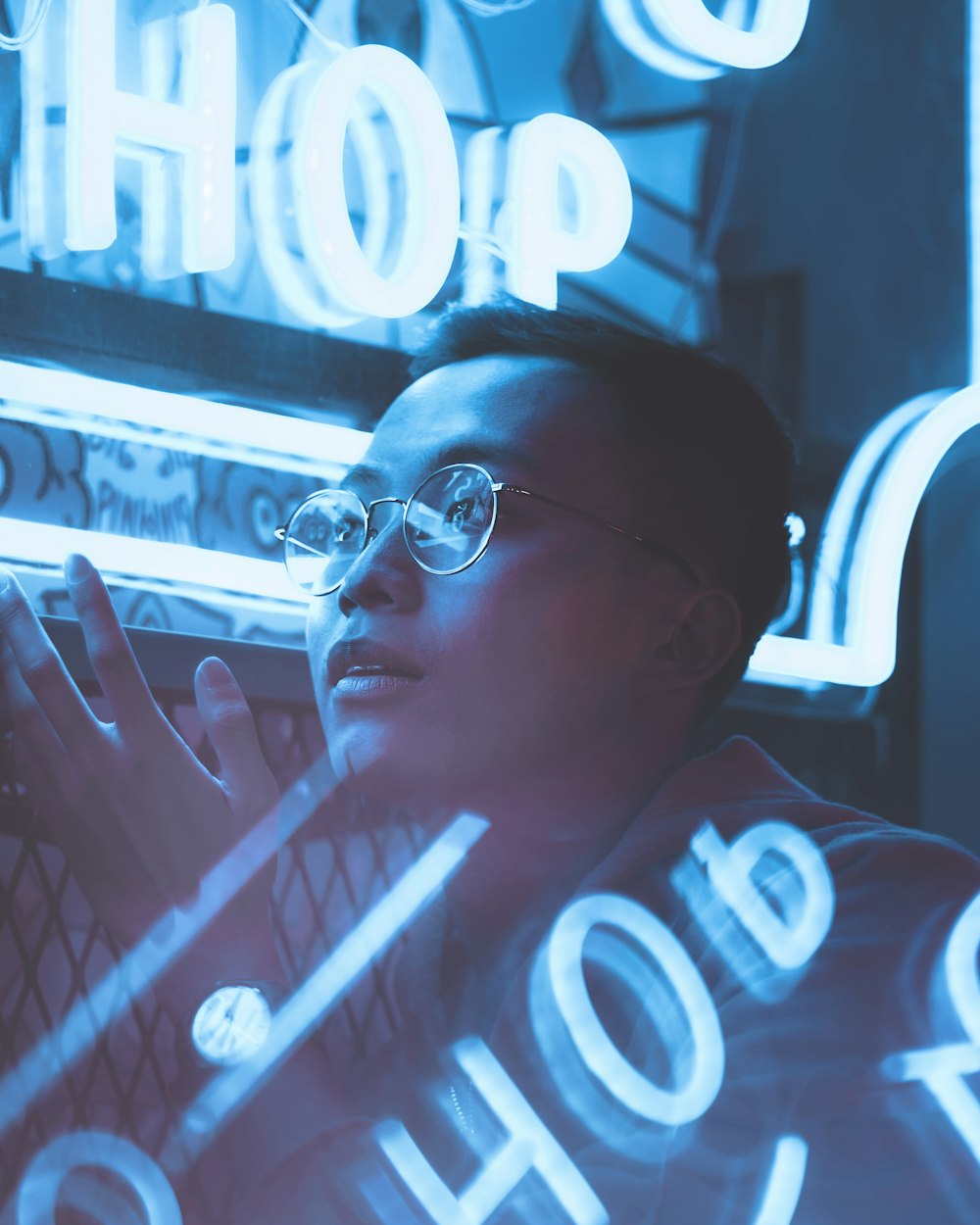 a woman wearing glasses is looking at a computer screen