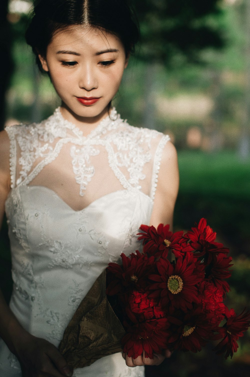 woman holding red flowers