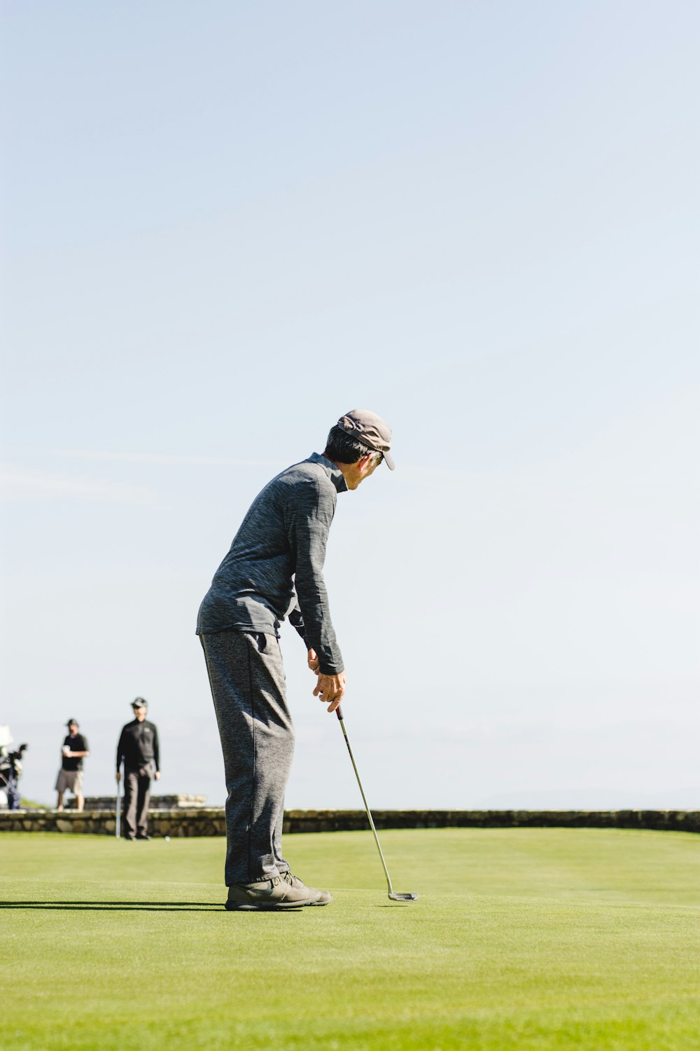 man playing golf in green fields