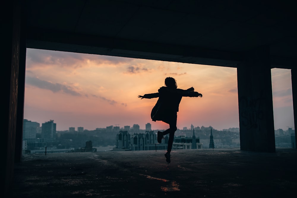 person walking and raising both hands