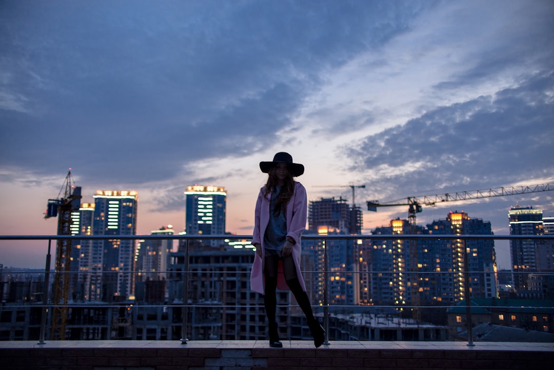 woman standing near metal fence