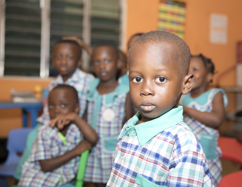 children in plaid button-up shirt uniform