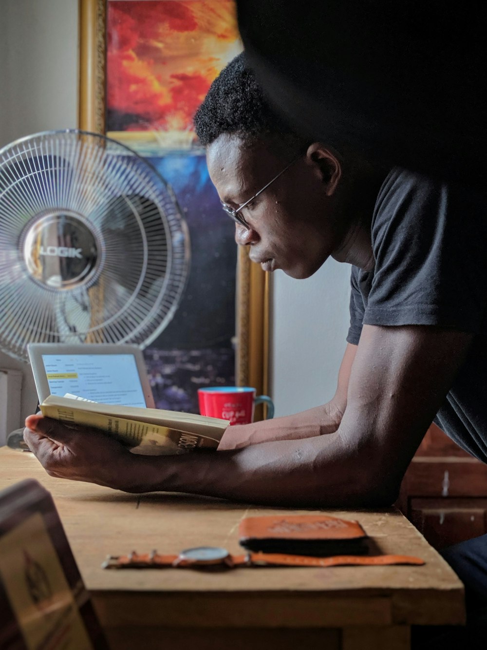 man reading a book at a desk