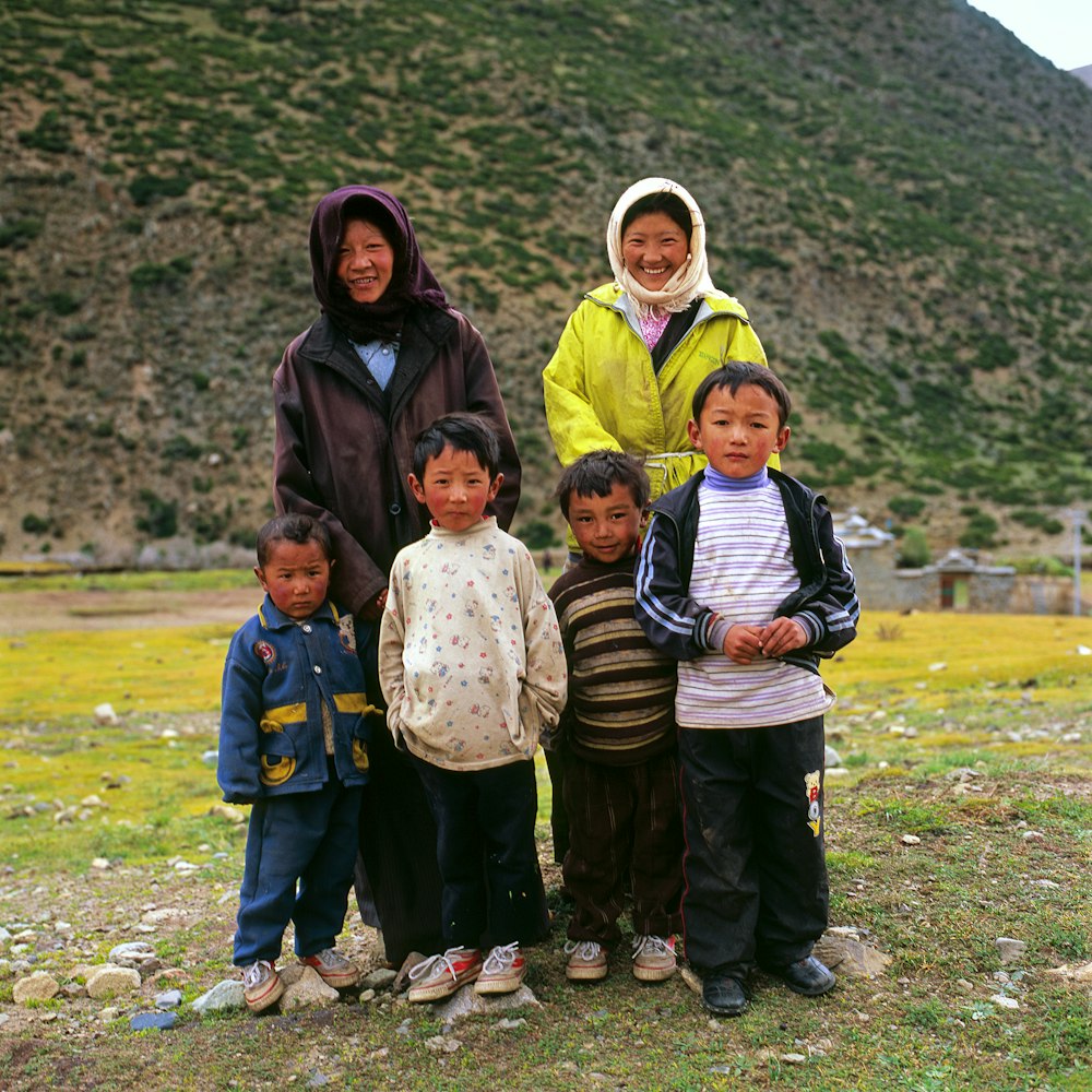 photo of six people across green and brown hills