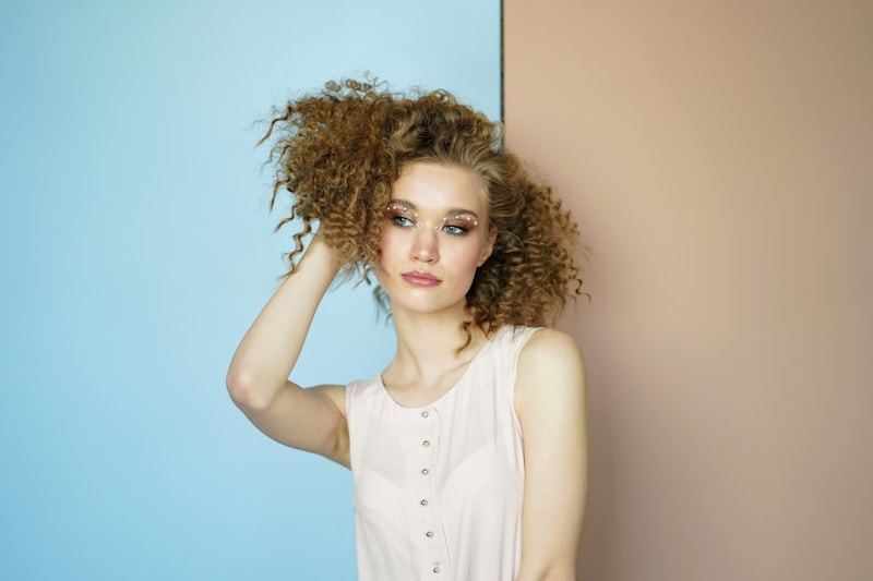 woman in casual pose against wall