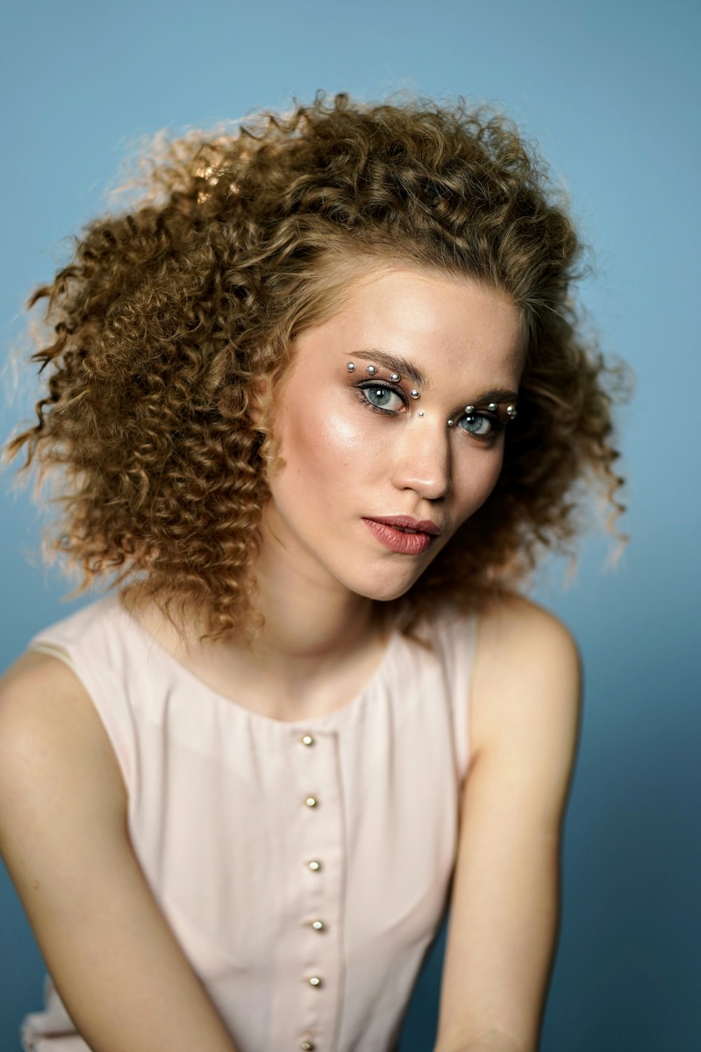 woman wearing beige sleeveless top