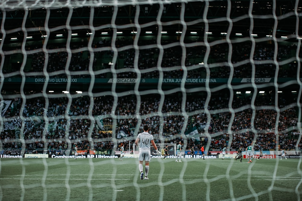 man standing on green soccer field