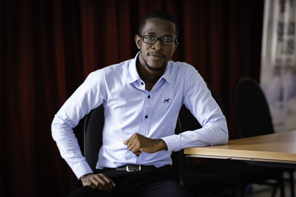 man sitting leaning on table