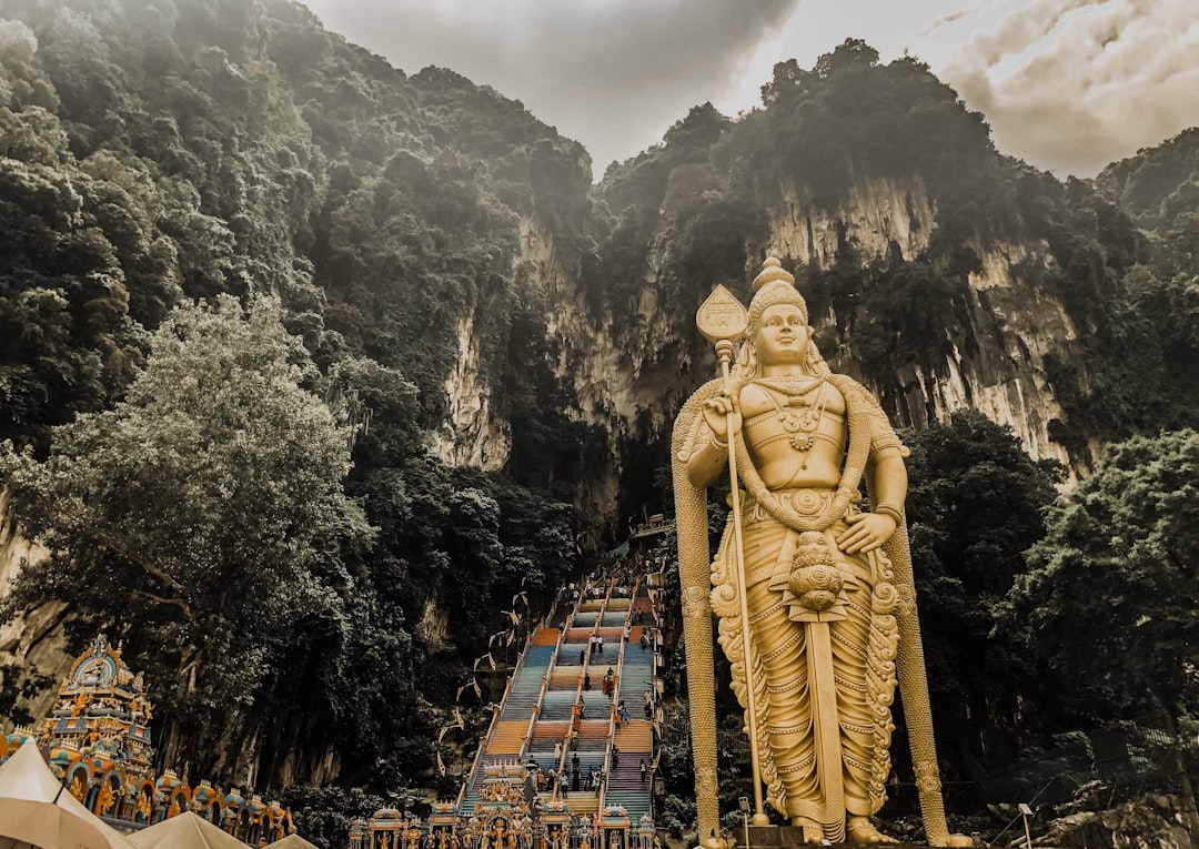 statue near mountain,