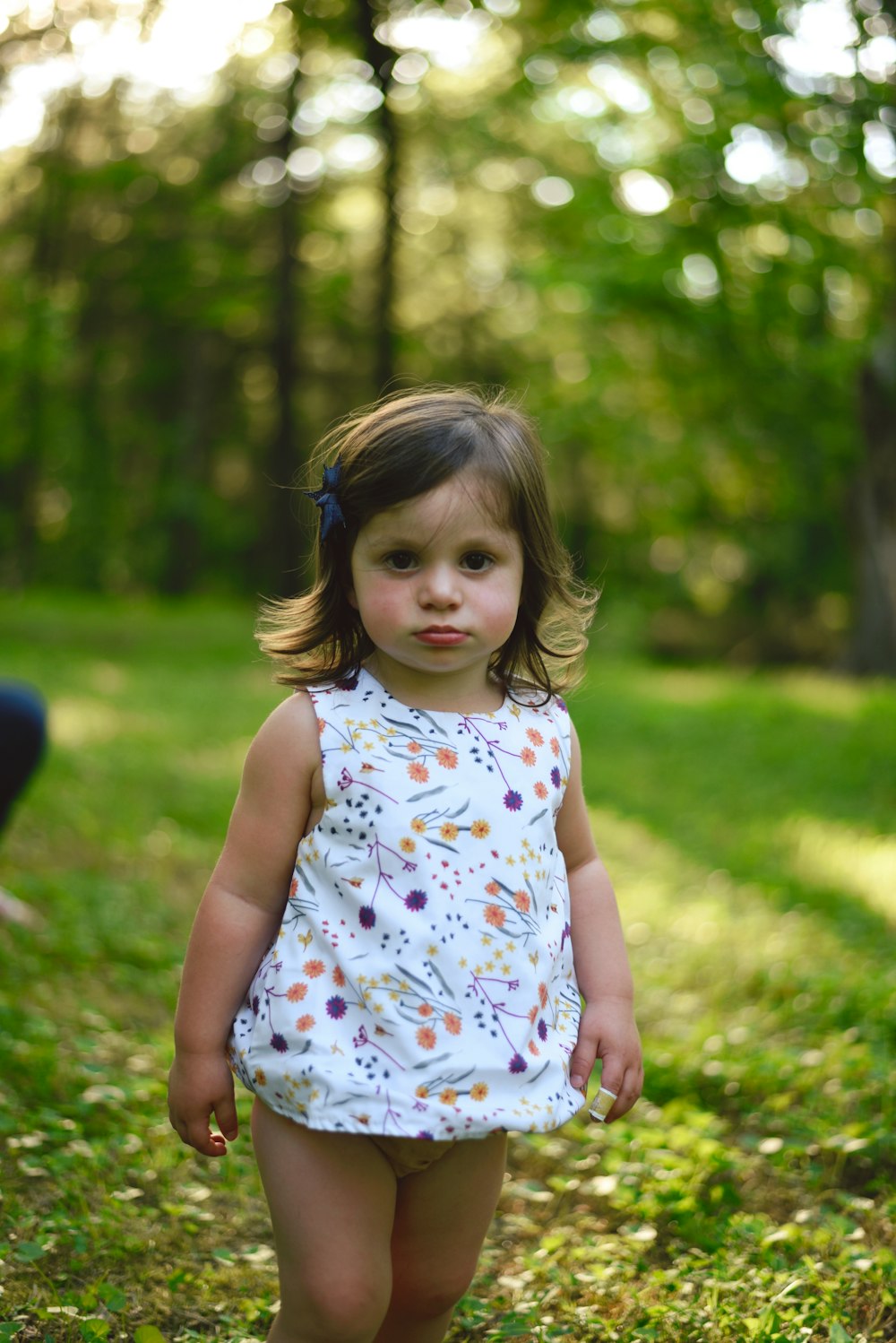 toddler girl standing on grass