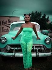 woman leaning on teal car