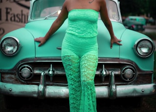 woman leaning on teal car