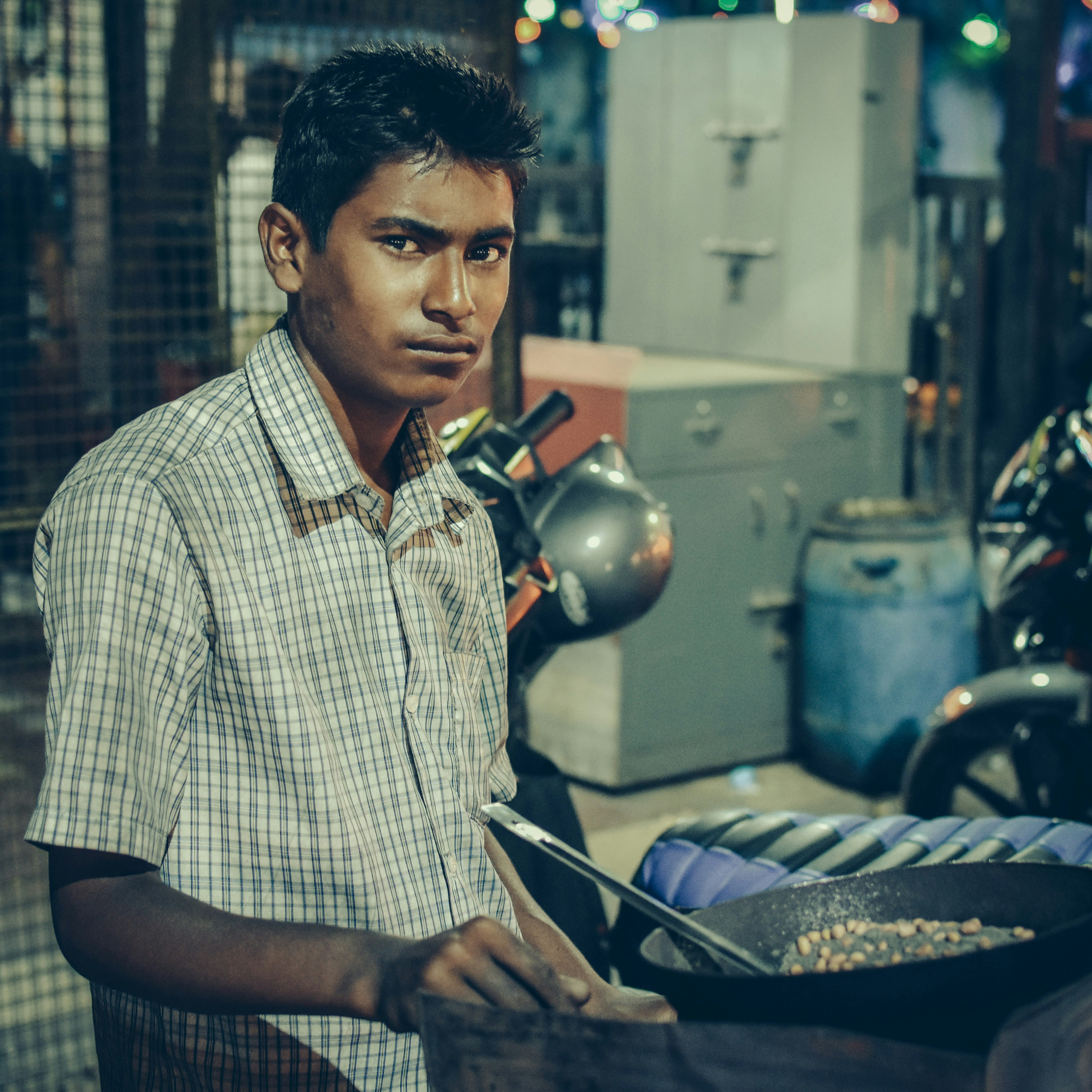 men near a cooking pan in a room close-up photography