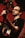 A musician with glasses plays a guitar and sings into a microphone. The background is a warmly lit stage with red and dark tones, subtle lighting highlights the musician's face and instrument.