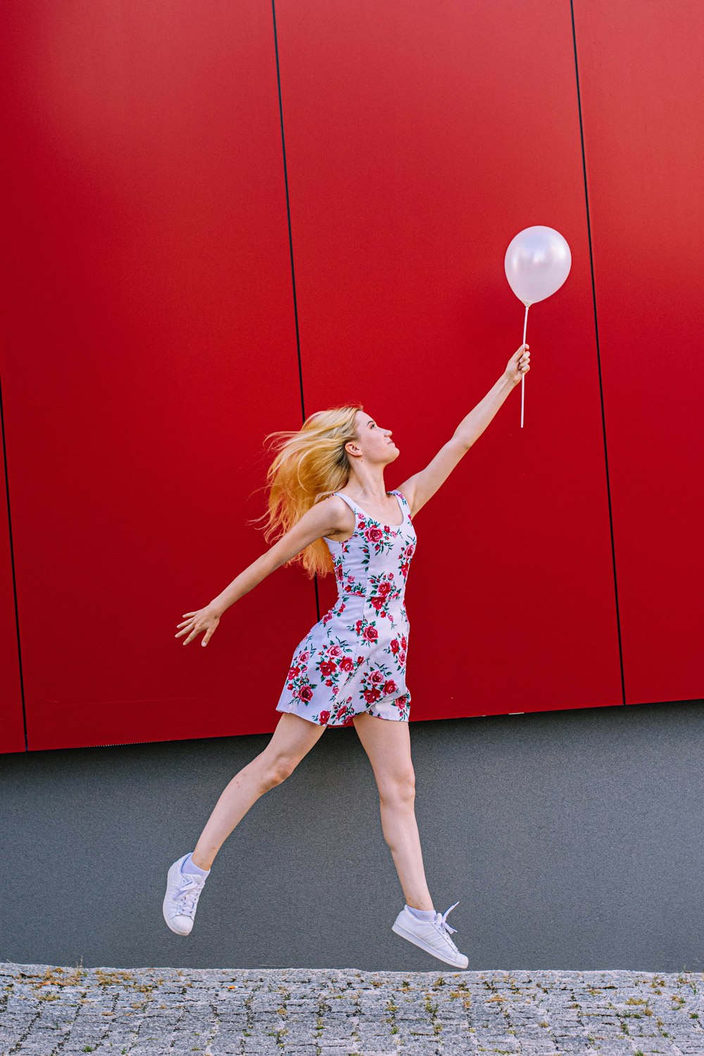 woman holding white balloon