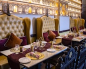 Elegant dining setup with deep green and royal gold accents reflecting the brand colors.