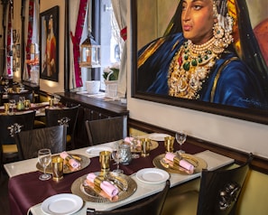 A beautifully arranged dining area with traditional Kashmiri decor and warm lighting.