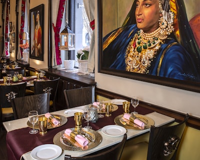 An elegant dining setup with Indian-inspired decor and tableware.