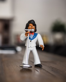 man singing figurine on selective focus photography