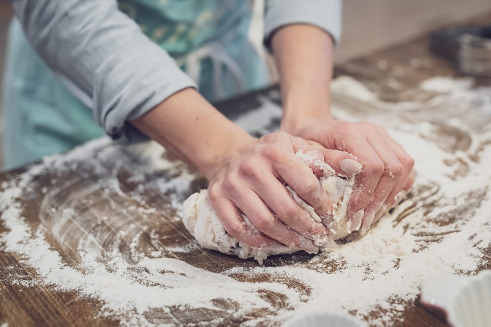 person standing and making dough