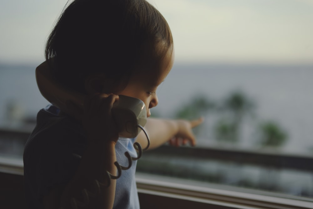 boy holding telephone