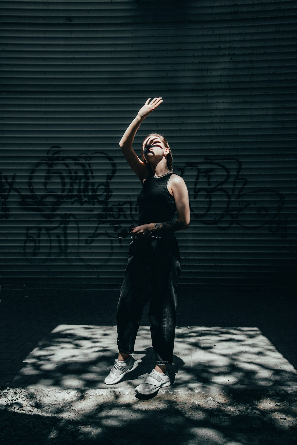 woman by a graffitied wall