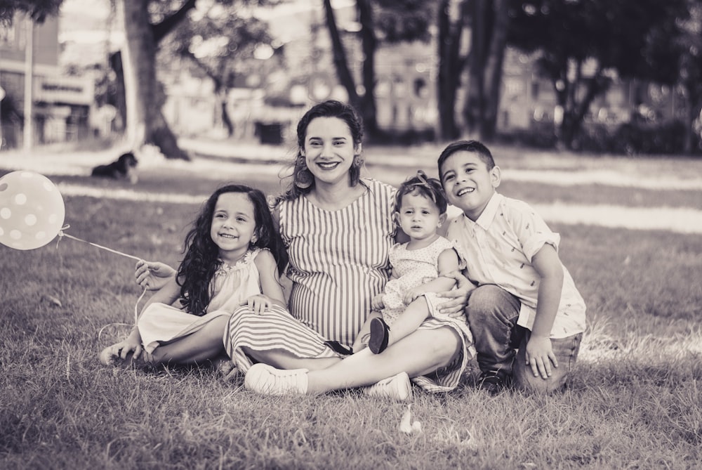 greyscale photo of woman and children