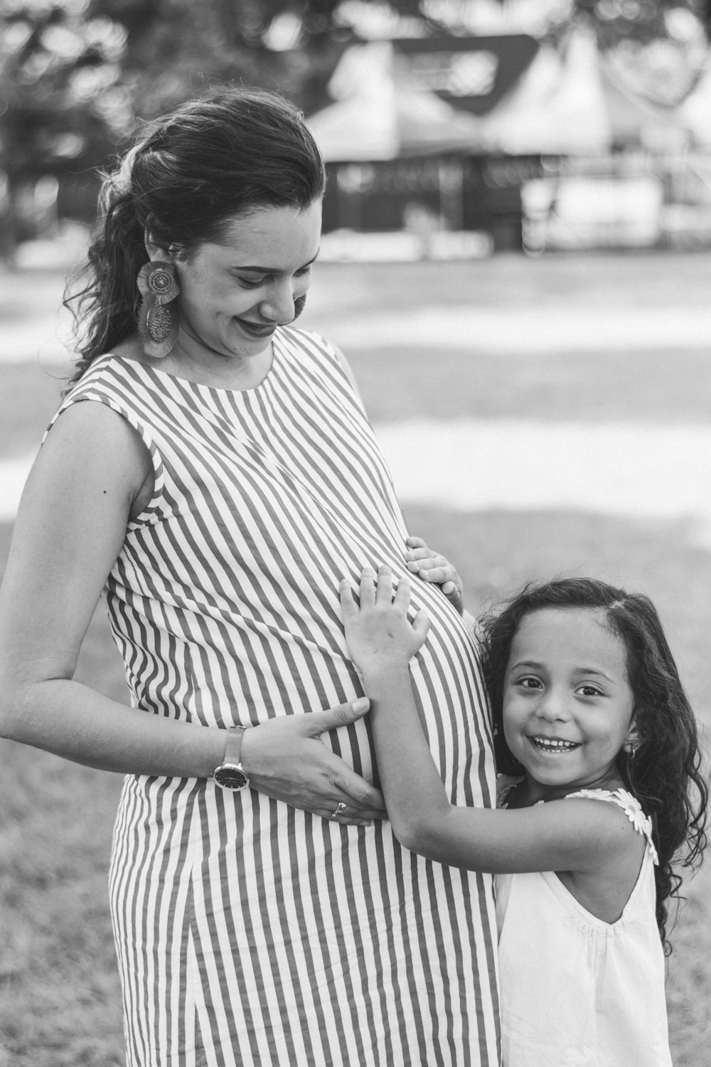 grayscale photography of pregnant woman and girl