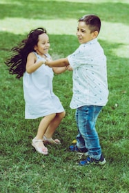 A cheerful family playing on a freshly cut, lush green lawn under bright sunlight.